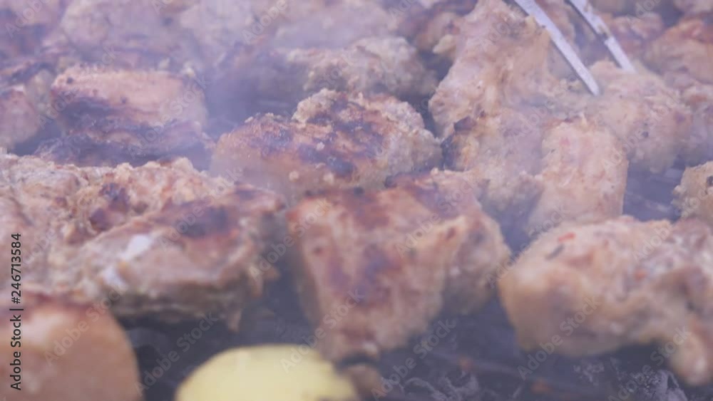 Grilled stake and potato on barbecue.