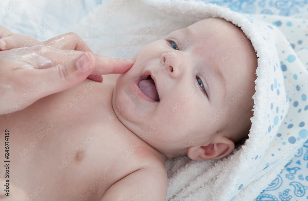 Applying cream over three months baby boy after bath Applying cream over three months baby boy after bath