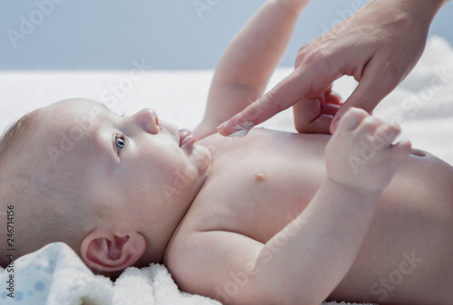 Applying cream over three months baby boy after bath © WH_Pics