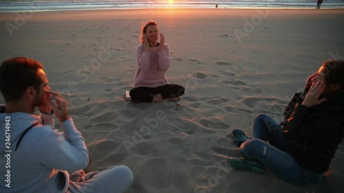 Yoga session on the beach with coach men and woman.