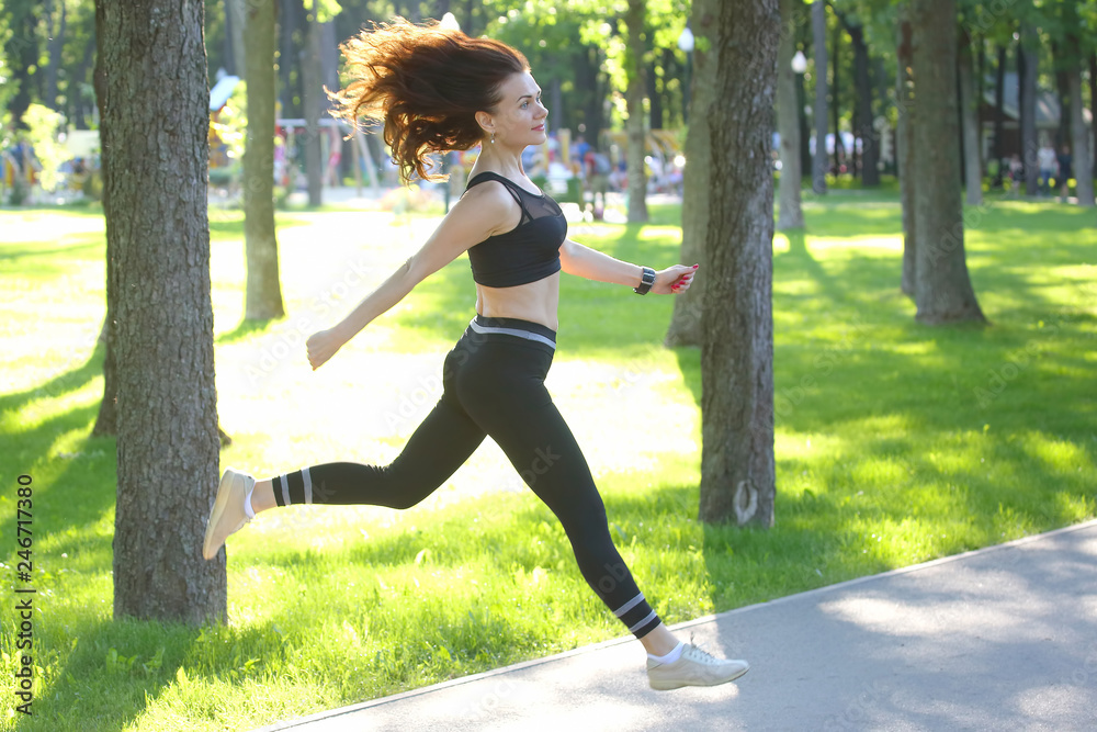 cute young sporty girl in jump running at a distance cute young sporty girl in jump running at a distance