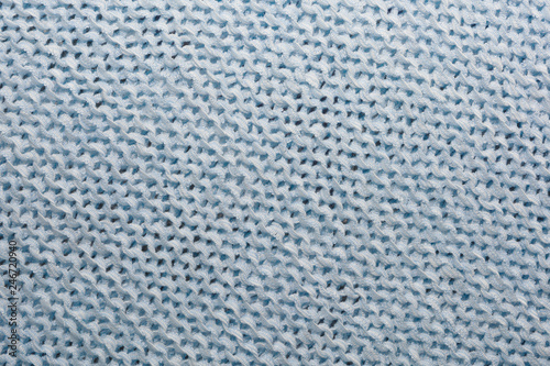 The texture of the knitted blue fabric for the background   