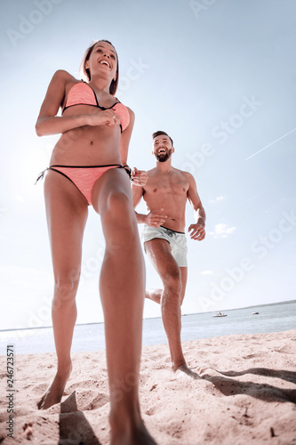 Happy couple spending carefree time on the beach outdoors.