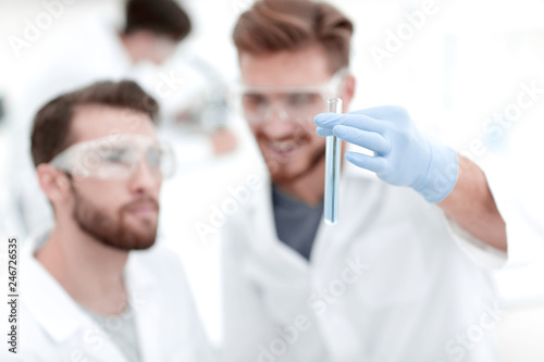 two scientists examining liquid in a test tube