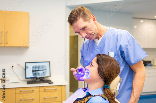 Female patient at dentis teeth whitening procedure