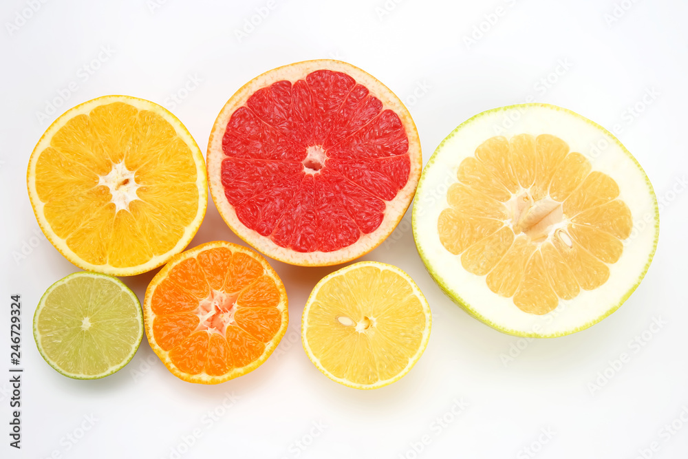 cut pieces of different citrus fruits on white background cut pieces of different citrus fruits on white background