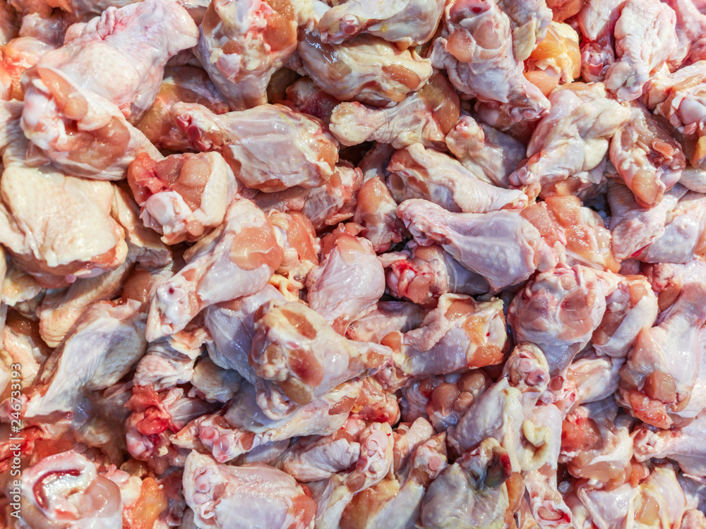 Fresh chicken wings. Colorful background texture.