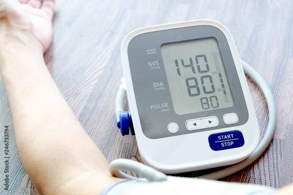 Human check blood pressure monitor and heart rate monitor with digital pressure gauge. Health care and Medical concept Human check blood pressure monitor and heart rate monitor with digital pressure gauge. Health care and Medical concept