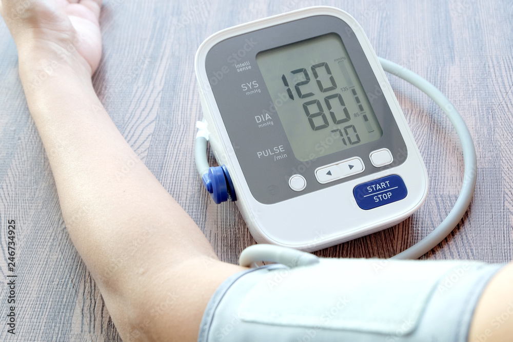 Human check blood pressure monitor and heart rate monitor with digital pressure gauge. Health care and Medical concept Human check blood pressure monitor and heart rate monitor with digital pressure gauge. Health care and Medical concept