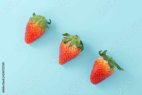 Fototapeta Naklejka Na Ścianę i Meble -  Strawberries on light blue background, flat lay