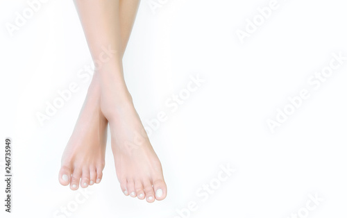 Beautiful female legs and feet on a white background.Concept beauty and hydration of the skin. © Photo Sesaon