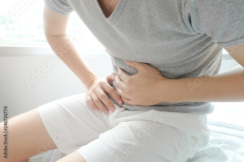 People have abdominal pain. Take a hand from the belly diarrhea.Health concept