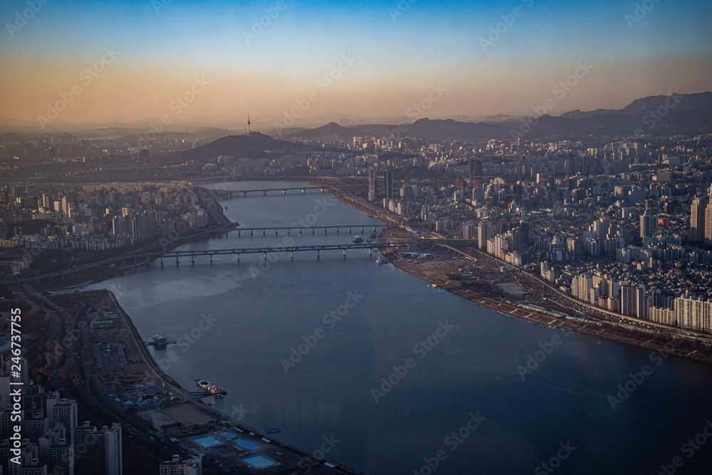 Aerial view cityscape of Seoul, South Korea. Aerial View Lotte tower at Jamsil. View of Seoul with river and mountain. Seoul downtown city skyline, Aerial view of Seoul