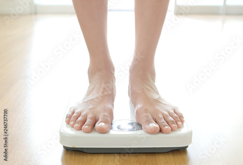 Legs of men standing on scales weight. Concept of health and weight loss.