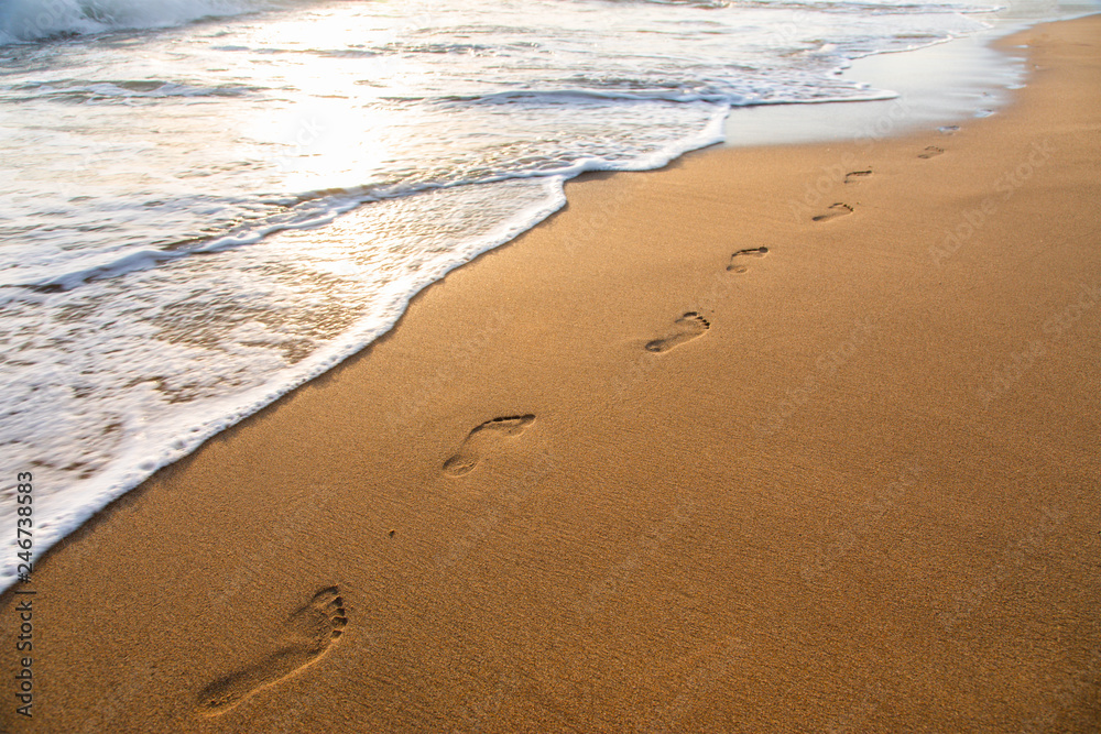 beach, wave and footprints at sunset time beach, wave and footprints at sunset time