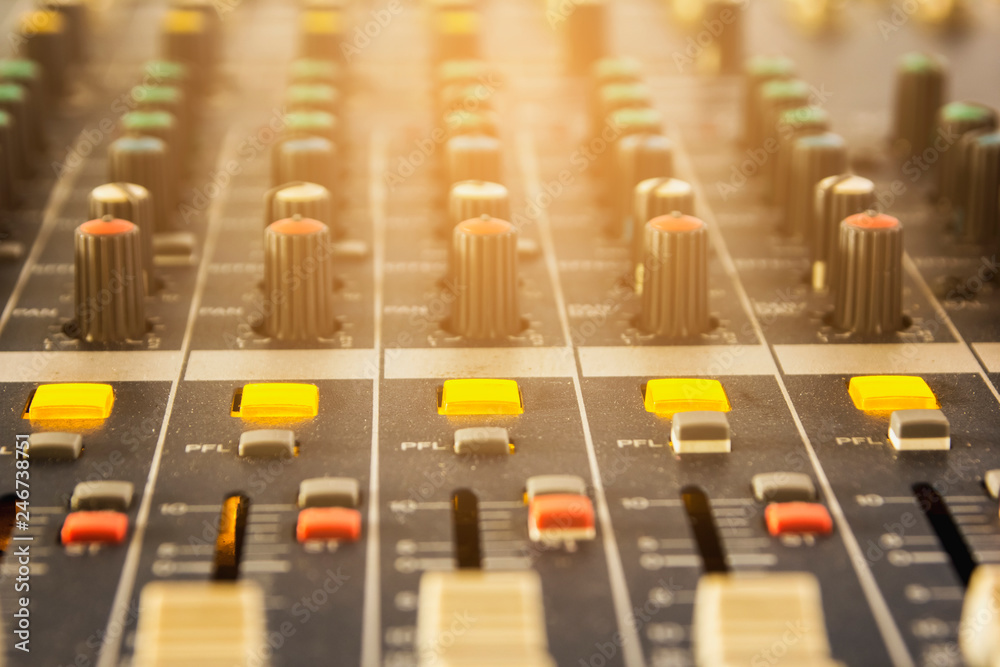 Obraz premium Slide the button to adjust the volume mixer of audio professionals. In the studio recording.