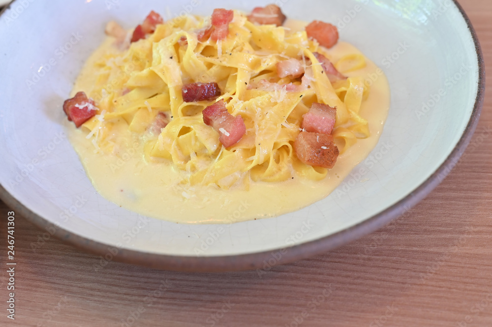 fettucine white cream sauce in white plate. fettucine white cream sauce in white plate.