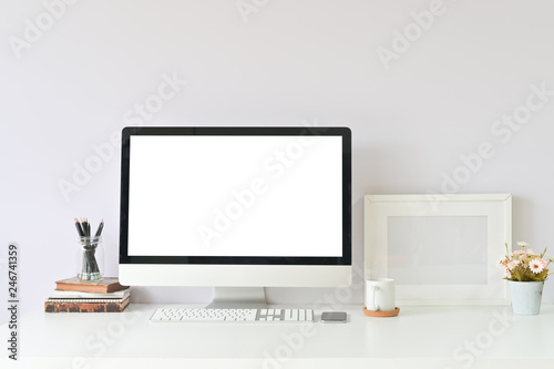 Workspace table office supplies on creative workplace with mockup computer empty display.