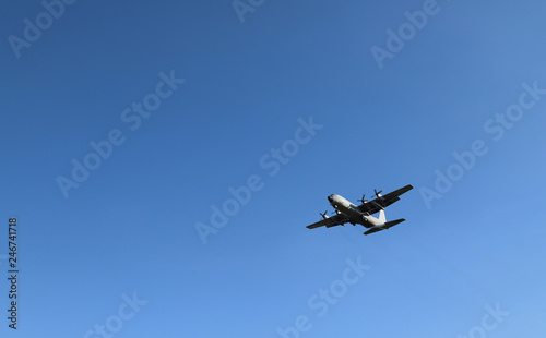 Scenery of airplane flying in clear blue sky of sunny day. The best way of transportation in modern world. 