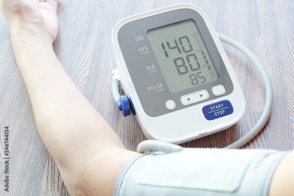 Man check blood pressure monitor and heart rate monitor with digital pressure gauge. Health care and Medical concept Man check blood pressure monitor and heart rate monitor with digital pressure gauge. Health care and Medical concept