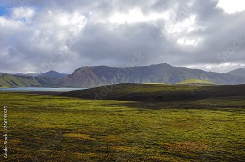 Lake and moss-covered volcanic mountains. Landmannalaugar. Iceland