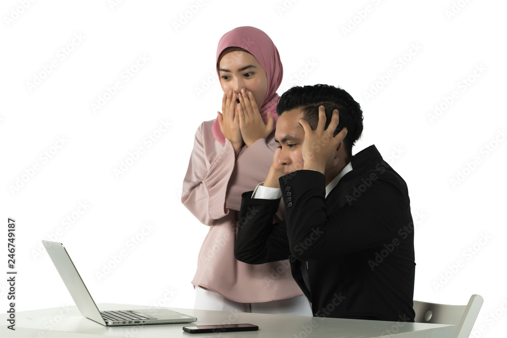 asian couple shocked with result on the laptop screen asian couple shocked with result on the laptop screen
