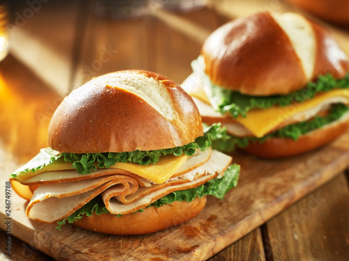 Quadro su tela two cold cut style turkey and cheese sandwiches on pretzel buns