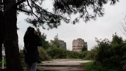 Girl Taking Picture of Old Fortress and Bosphorus Mist Aerial View photo