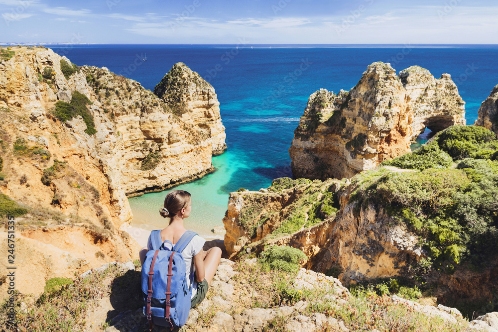 Young woman traveler looking at the sea in Lagos town, Algarve region, Portugal. Travel and active lifestyle concept Young woman traveler looking at the sea in Lagos town, Algarve region, Portugal. Travel and active lifestyle concept