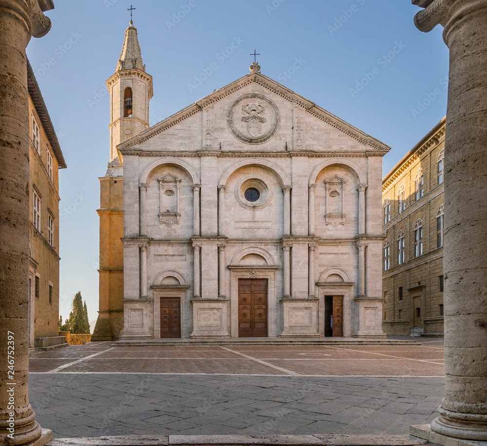 Pio II square and the Duomo of Pienza framed by the columns of the town hall, Siena, Tuscany, Italy