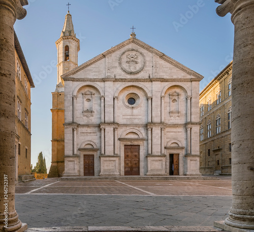 Pio II square and the Duomo of Pienza framed by the columns of the town hall, Siena, Tuscany, Italy