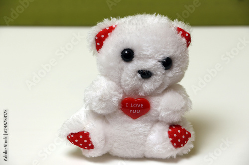 White bear with a heart on a white background isolated.