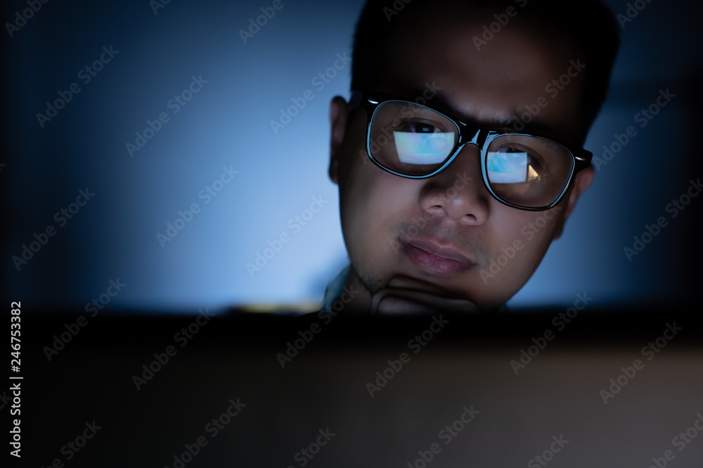 Focused and serious looking man working and thinking hard on computer Focused and serious looking man working and thinking hard on computer