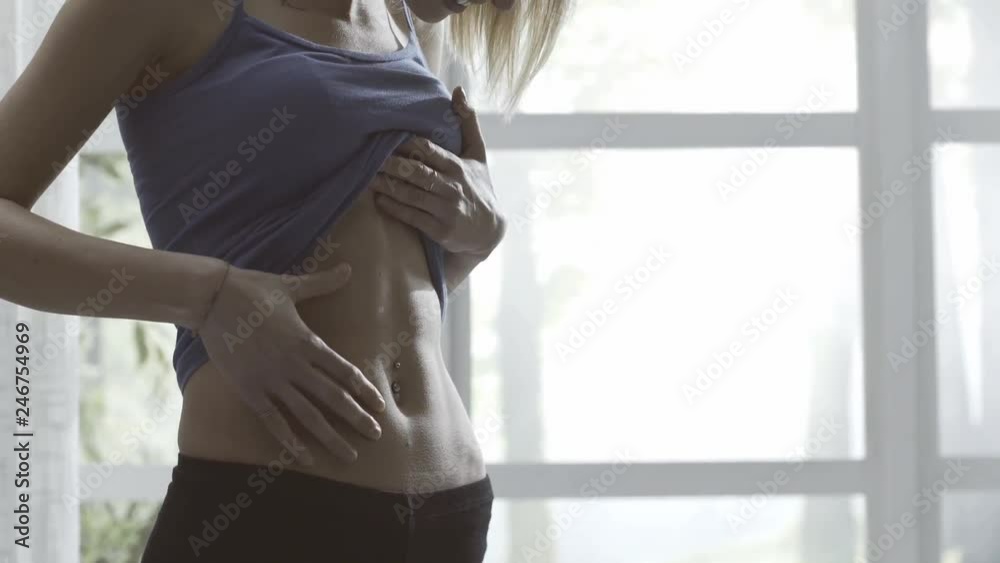 Young woman showing her flat belly
