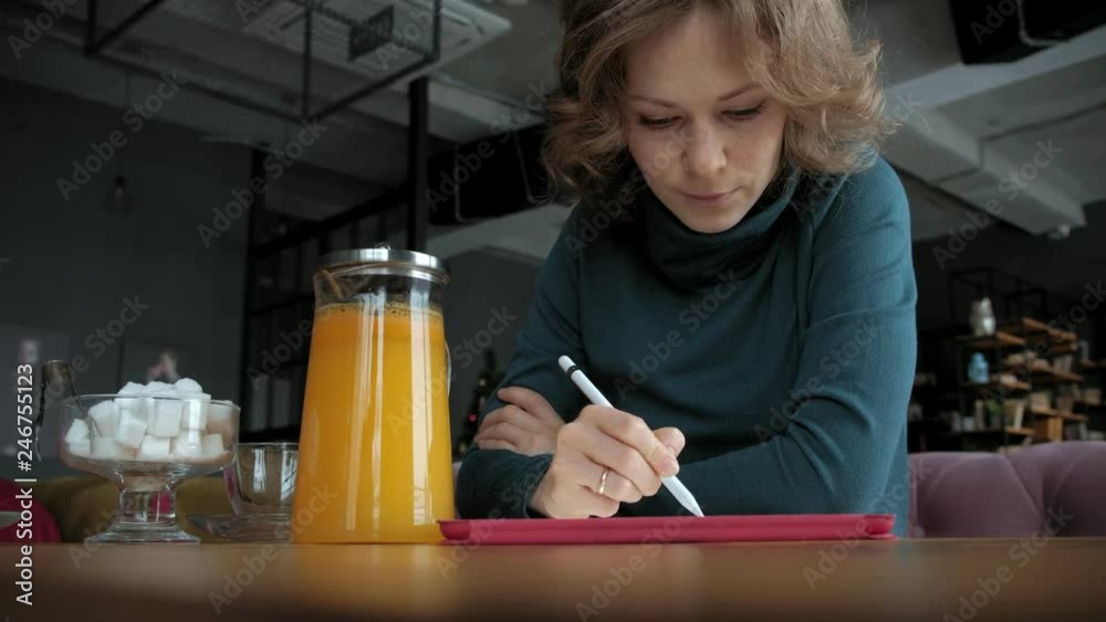Attractive young woman with tablet in cafe, freelancer concept Attractive young woman with tablet in cafe, freelancer concept