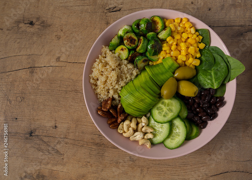 budha bowl with brussel cabbage, corn, quinoa, cucumbers,nuts, avocado and spinach