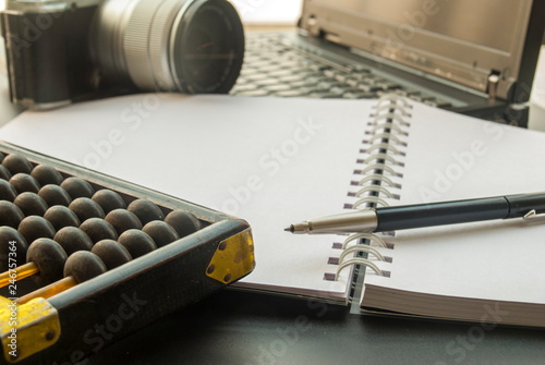 Work devices with laptops, notebooks, cameras and abacus