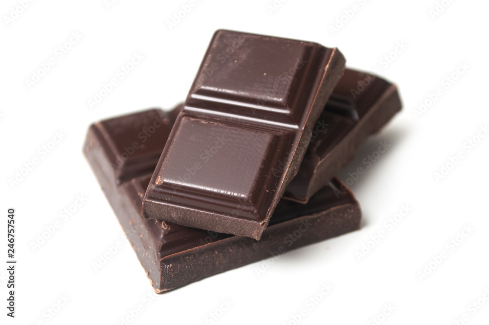 closeup of milk chocolate blocks on white background closeup of milk chocolate blocks on white background