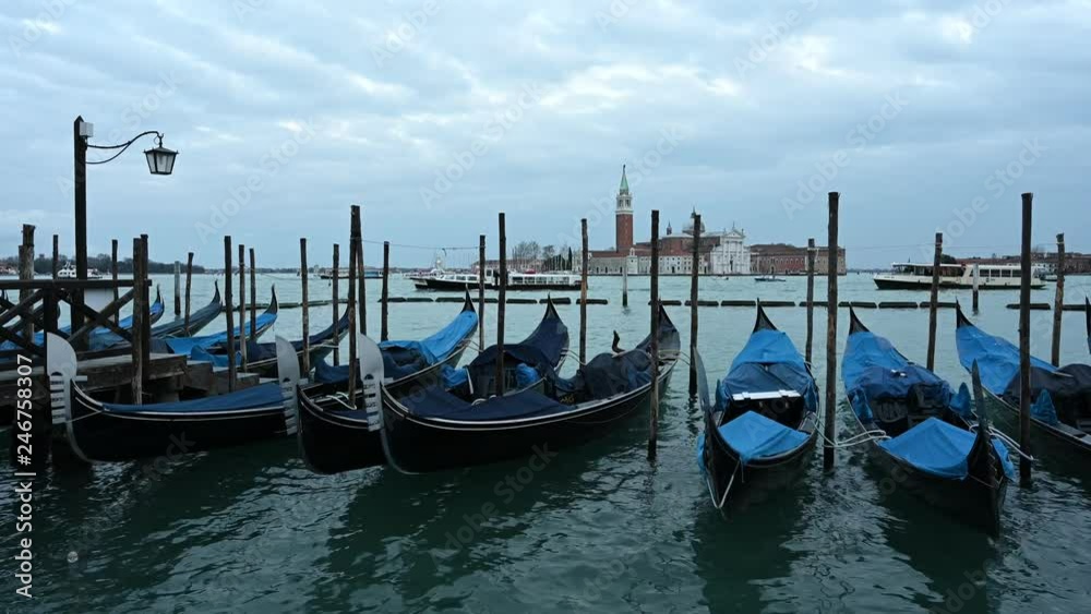 Gondolas and other boats at dusk in the basin of San Marco Gondolas and other boats at dusk in the basin of San Marco