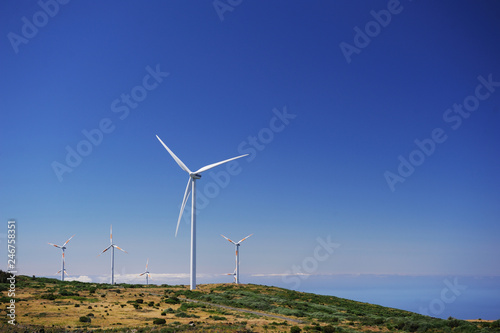 Aerogenerator Windmills In Front Of Ocean Sea