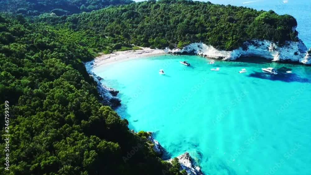 Aerial drone video of tropical paradise turquoise beach of Voutoumi with sail boats docked in island of Antipaxos, Ionian, Greece Aerial drone video of tropical paradise turquoise beach of Voutoumi with sail boats docked in island of Antipaxos, Ionian, Greece