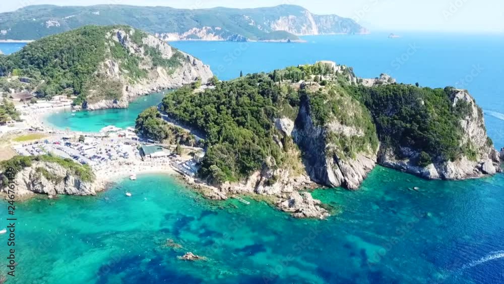 Aerial drone video of iconic Monastery of Palaiokastritsa near popular turquoise beach of Agios Spyridonas, Corfu island, Ionian, Greece