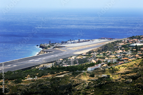 panoramic coastal view over the international airport of madeira, green succulents in front photo