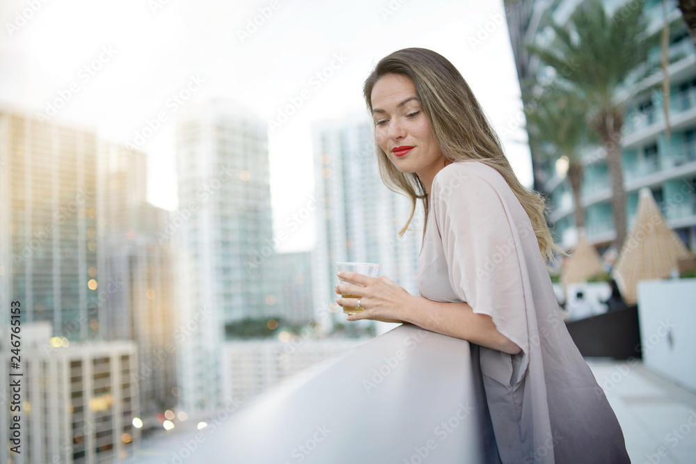 Atttractive elegant young woman on rooftop bar in the city Atttractive elegant young woman on rooftop bar in the city