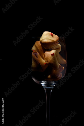 Delicious sweet shortbread biscuits with a prediction in a glass. Cookies with precog. Celebration. Wineglass. photo