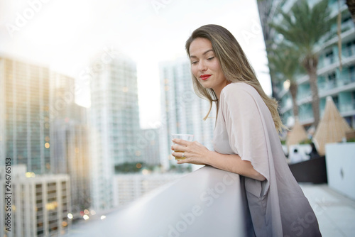 Free Download Atttractive elegant young woman on rooftop bar in the city - GFXLoad