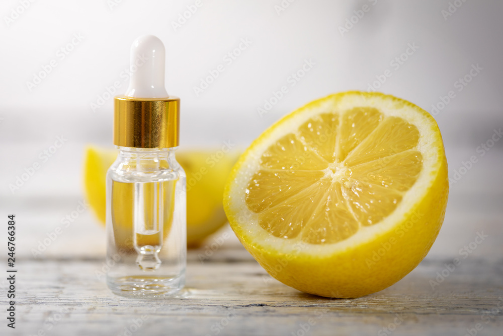 essential oil bottle with fresh lemon essential oil bottle with fresh lemon