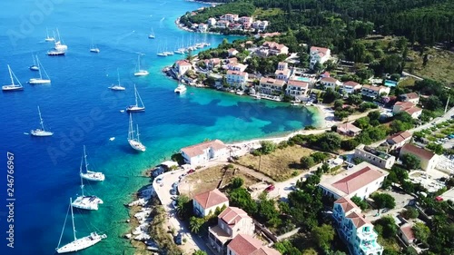 Aerial video from iconic traditional fishing village and bay of Fiskardo with beautiful houses and Ionian architecture, Cefalonia island, Greece photo