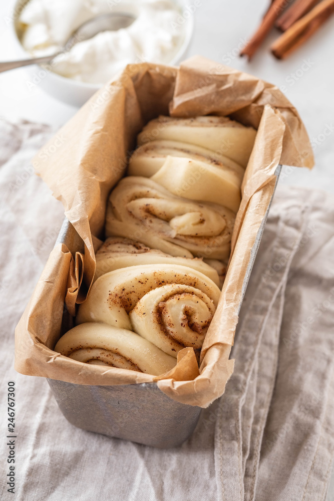 Raw cinnamon bread in a baking dish. Copy space. Raw cinnamon bread in a baking dish. Copy space.