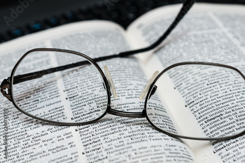 Closeup of Reading Glasses on Book 